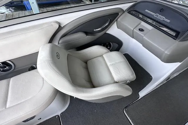 Slide: The Image of 2011 Cobalt 242 WSS boat interior with plush seating and sleek dashboard design. - 11