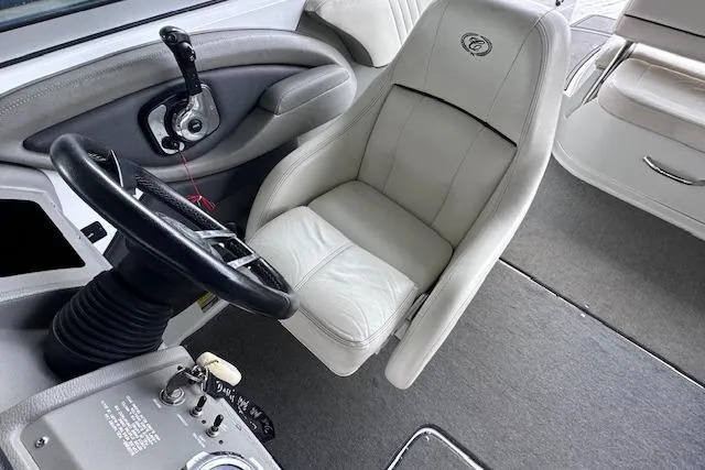 Slide: The Image of 2011 Cobalt 242 WSS boat interior with steering wheel and captain's chair. - 14