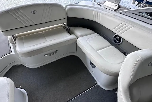 Slide: The Image of 2011 Cobalt 242 WSS boat interior with gray seating and carpeted floor. - 15