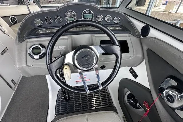 Slide: The Image of 2011 Cobalt 242 WSS boat dashboard with steering wheel and instrument panel. - 16
