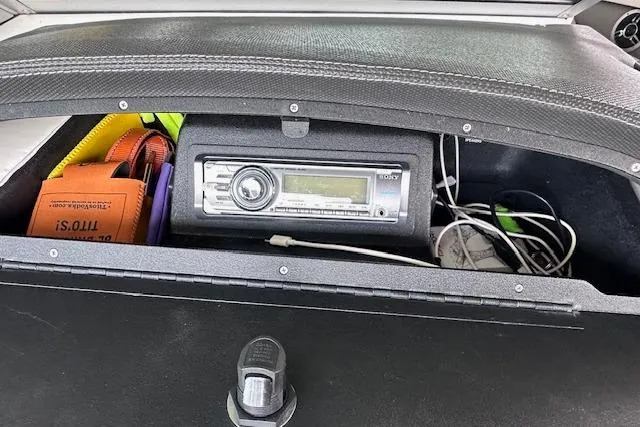 Slide: The Image of Storage compartment in a 2011 Cobalt 242 WSS boat with stereo system and accessories. - 18