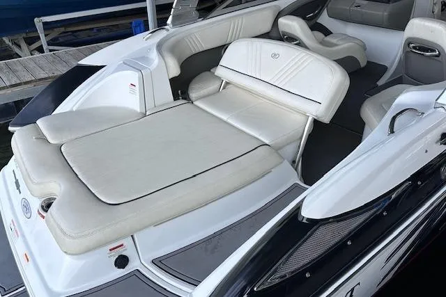 Slide: The Image of 2011 Cobalt 242 WSS boat interior with white leather seating and sun pad. - 19