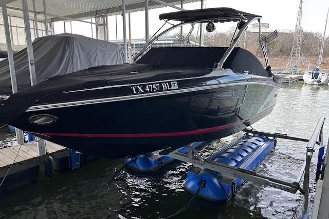 Slide: The Image of 2011 Cobalt 242 WSS boat on lift at marina dock. - 23