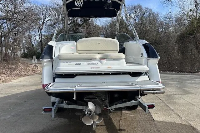 Slide: The Image of 2011 Cobalt 242 WSS boat on trailer, rear view, parked on a concrete driveway. - 3