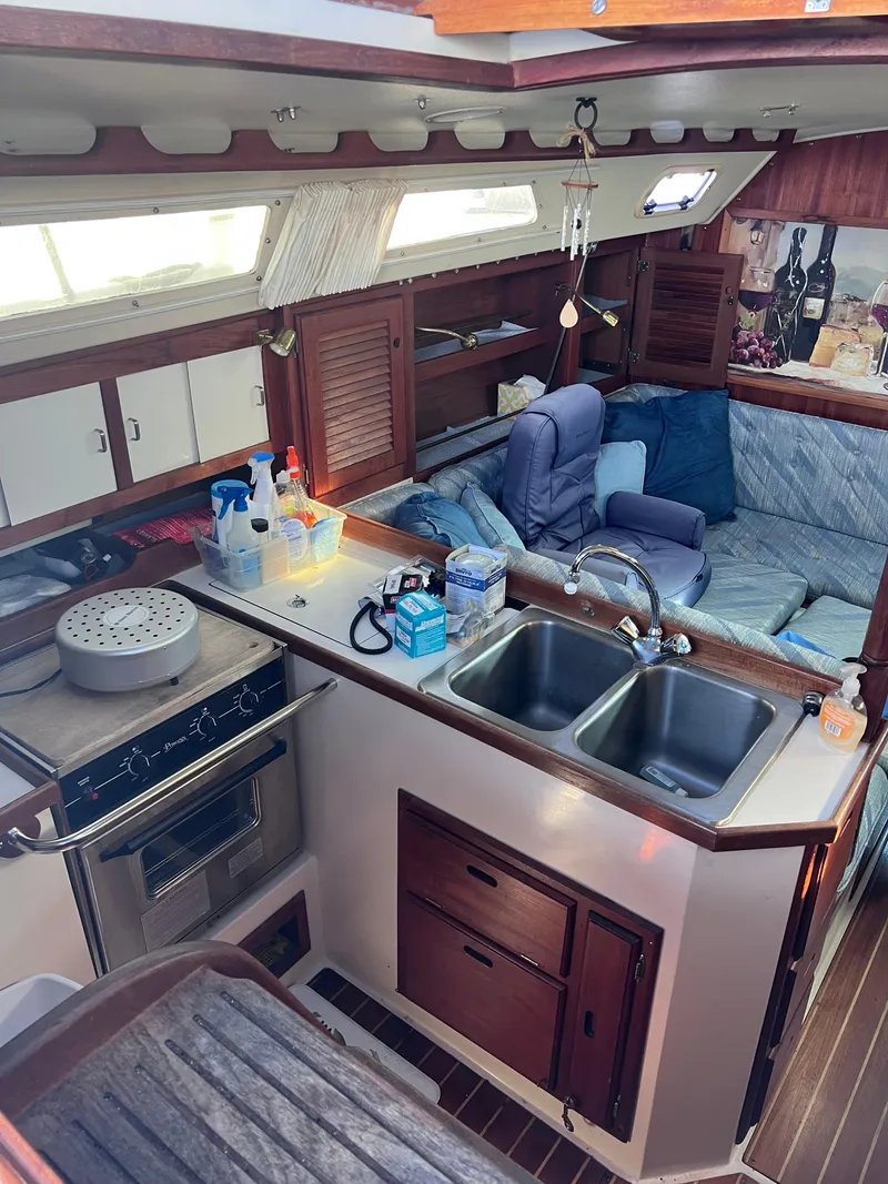 Slide: The Image of Interior of a 1989 Catalina 36 sailboat with kitchen and seating area. - 10