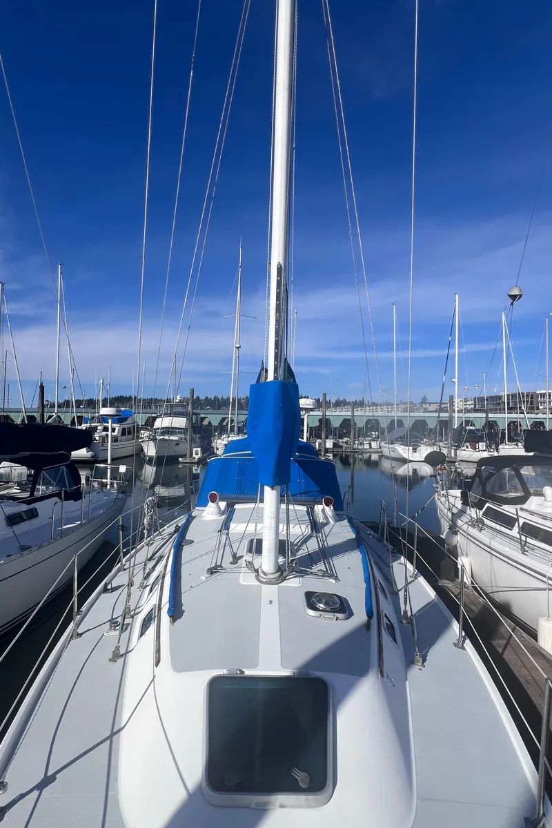 Slide: The Image of 1989 Catalina 36 sailboat docked in marina under clear blue sky. - 12