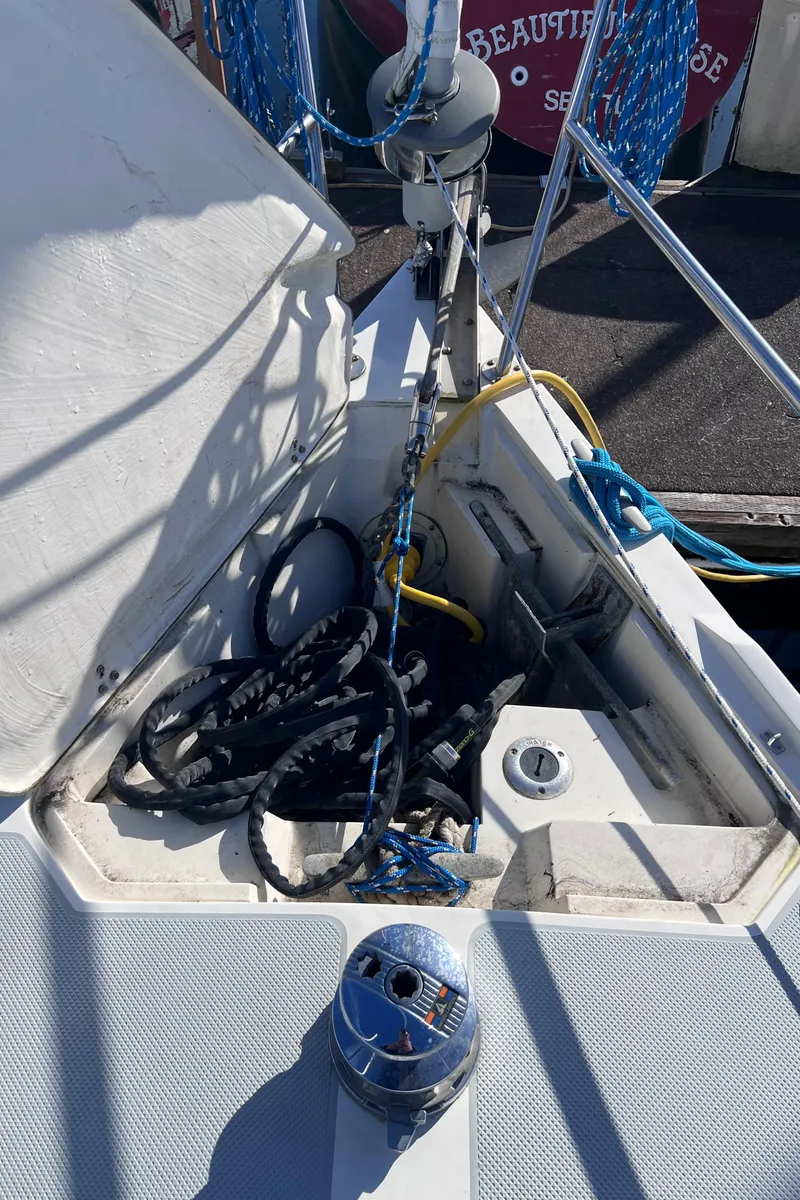 Slide: The Image of 1989 Catalina 36 sailboat deck with ropes and winch in marina setting. - 13