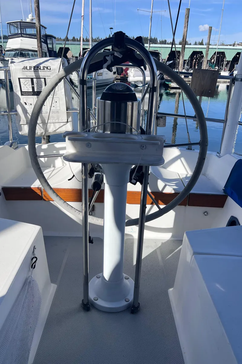 Slide: The Image of 1989 Catalina 36 sailboat helm with wheel, docked in a marina. - 14