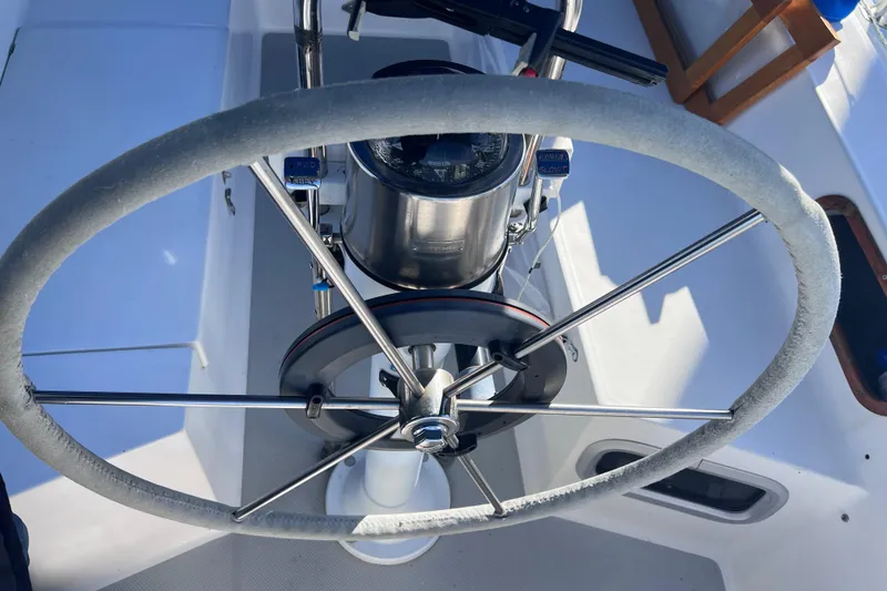 Slide: The Image of Steering wheel of a 1989 Catalina 36 sailboat, featuring a compass and control panel. - 15