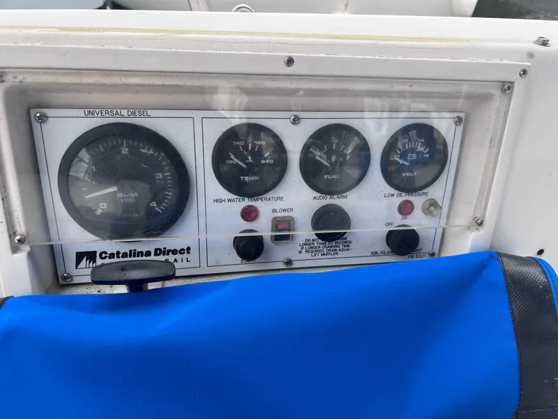 Slide: The Image of Control panel of a 1989 Catalina 36 sailboat with gauges and blue cover. - 17