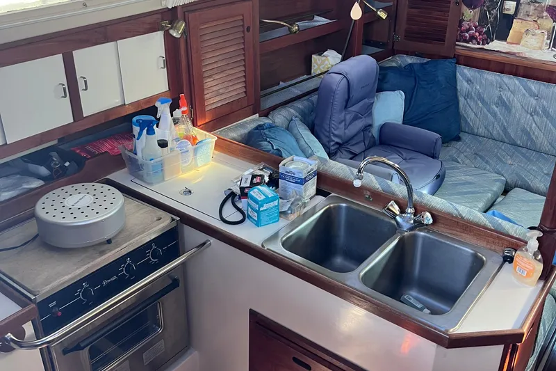 Slide: The Image of Interior of 1989 Catalina 36 sailboat with kitchen and seating area. - 25