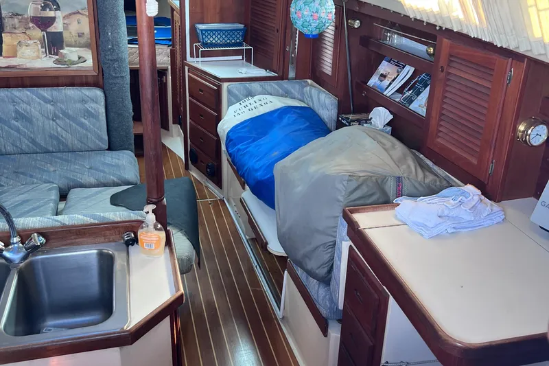 Slide: The Image of Interior of a 1989 Catalina 36 sailboat with cozy living space and wooden finishes. - 26