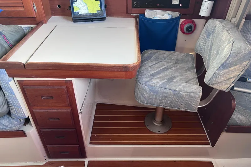 Slide: The Image of Navigation station in a 1989 Catalina 36 sailboat with chart table and swivel chair. - 30