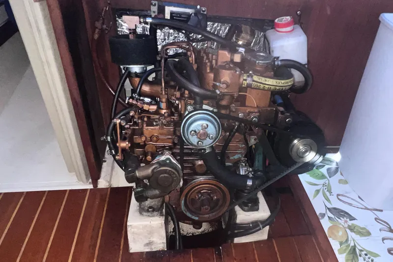 Slide: The Image of Engine of a 1989 Catalina 36 sailboat, showcasing mechanical components and surrounding interior. - 36