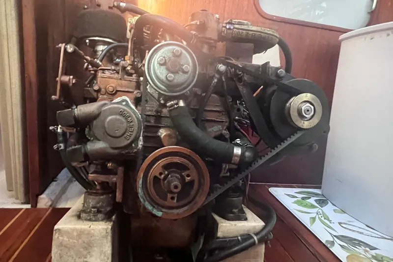Slide: The Image of Engine of a 1989 Catalina 36 sailboat, showcasing mechanical components and belts. - 37