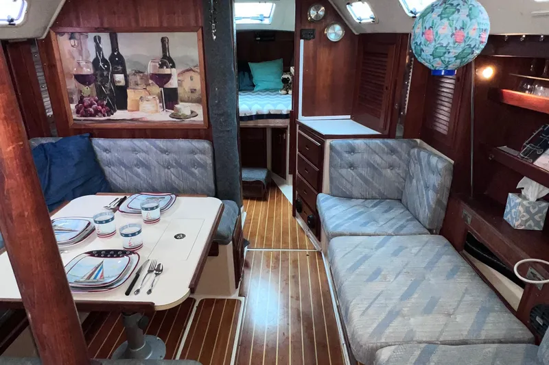 Slide: The Image of Interior of a 1989 Catalina 36 sailboat with cozy seating and dining area. - 4