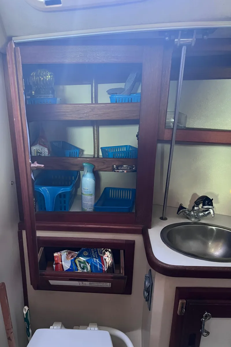 Slide: The Image of Interior of 1989 Catalina 36 sailboat with shelves, sink, and storage. - 40