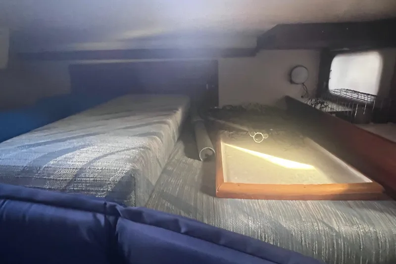 Slide: The Image of Interior cabin of a 1989 Catalina 36 sailboat with bedding and window. - 42