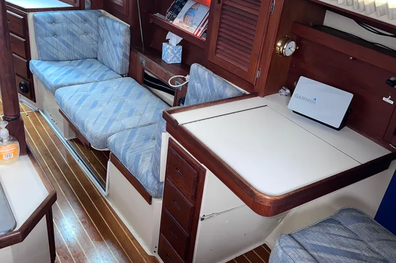 Slide: The Image of Interior of 1989 Catalina 36 sailboat with wood accents and blue upholstery. - 43