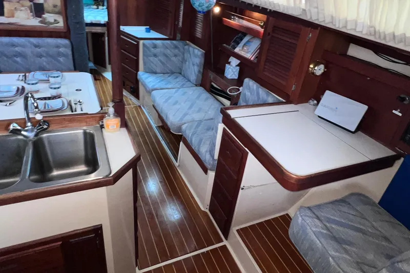 Slide: The Image of Interior of a 1989 Catalina 36 sailboat with wood accents and cozy seating. - 45