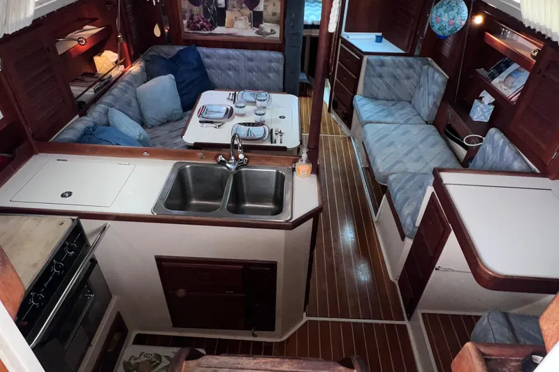 Slide: The Image of Interior of a 1989 Catalina 36 sailboat with cozy seating and dining area. - 46