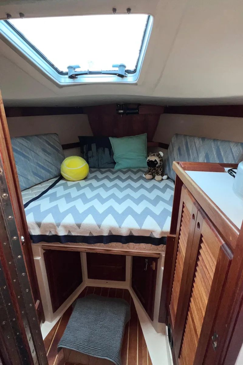 Slide: The Image of 1989 Catalina 36 cabin interior with bed, pillows, and skylight. - 49