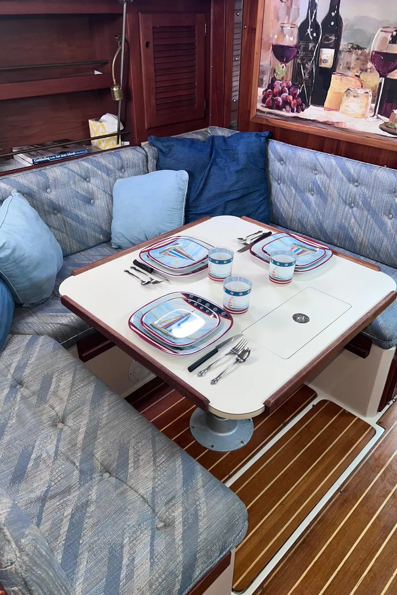 Slide: The Image of Cozy dining area in a 1989 Catalina 36 sailboat with elegant table setting. - 51