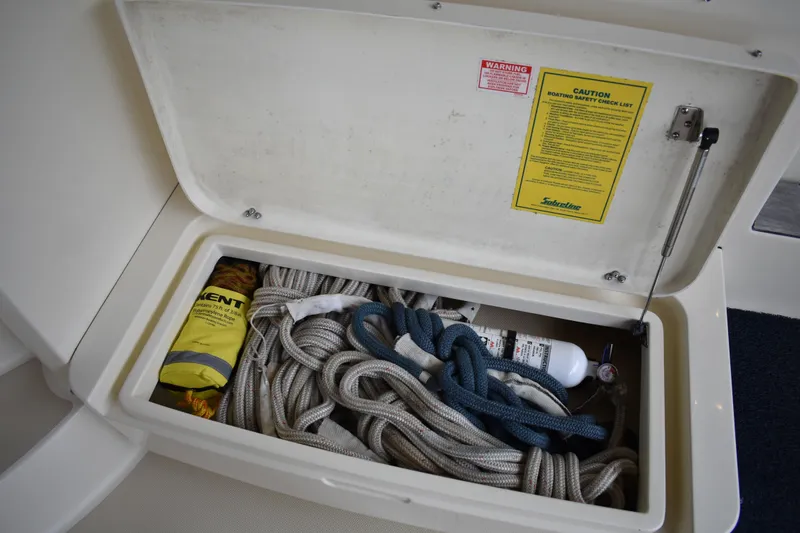 Slide: The Image of Starboard side of cockpit area with fresh water wash down quick connect hose fitting and a dockside water inlet. - 19