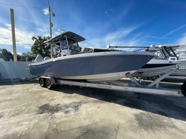 Slide: The Image of 2026 Caymas 291HB boat on trailer, blue sky. - 2