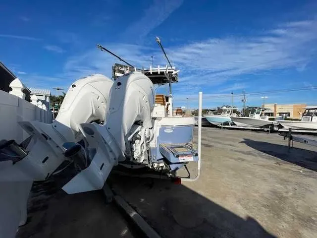Slide: The Image of 2026 Caymas 291HB boat with twin outboard engines at the dock. - 4