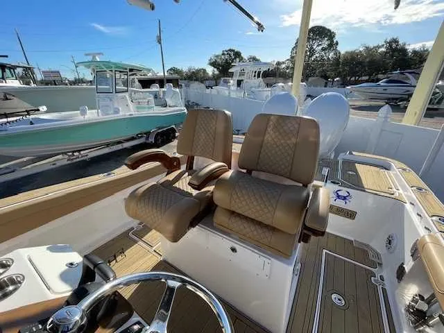 Slide: The Image of Interior of 2026 Caymas 291HB with luxurious seating and helm. - 7
