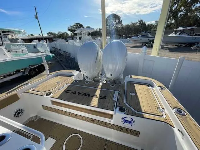 Slide: The Image of 2026 Caymas 291HB boat with dual engines at a marina. - 8
