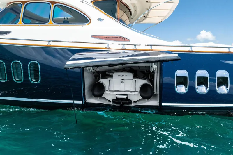 Slide: The Image of 2019 Zeelander Z55 yacht with open compartment revealing Turbojet engine on water. - 13