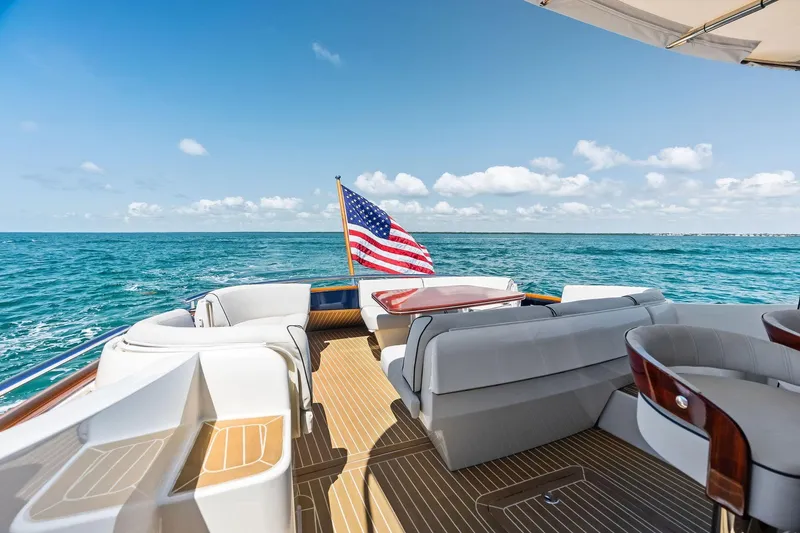 Slide: The Image of Luxurious 2019 Zeelander Z55 yacht deck with American flag, cruising on open sea. - 17
