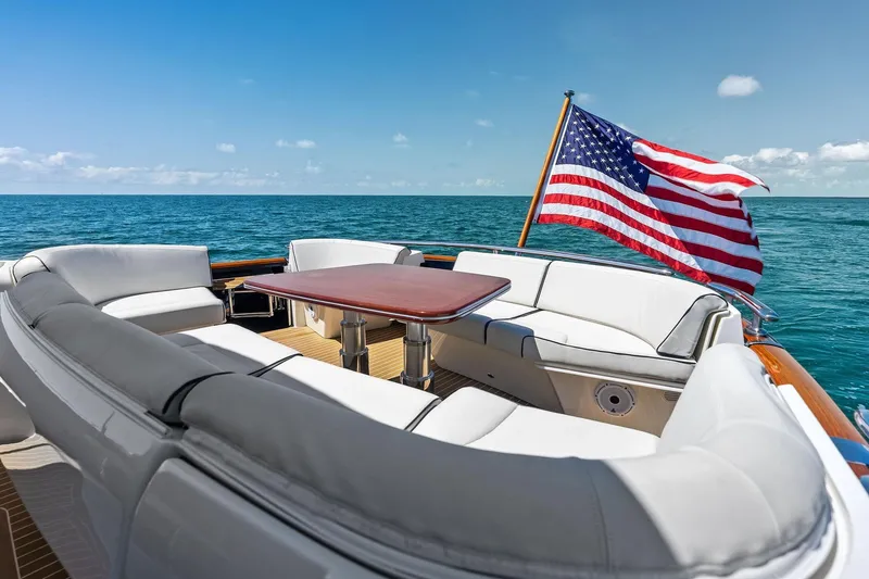 Slide: The Image of 2019 Zeelander Z55 yacht with American flag, featuring luxurious seating and ocean view. - 19
