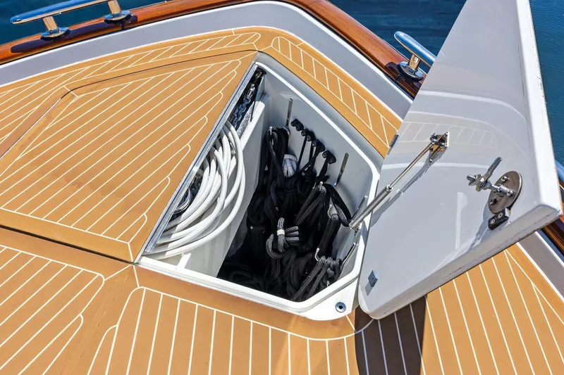 Slide: The Image of Open storage compartment on 2019 Zeelander Z55 yacht deck, containing ropes and cables. - 29