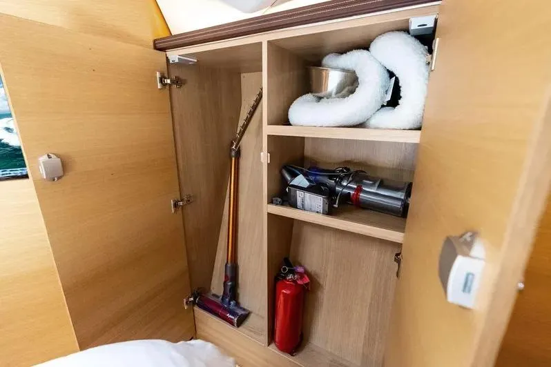 Slide: The Image of Storage cabinet on 2019 Zeelander Z55 yacht with cleaning tools and fire extinguisher. - 52