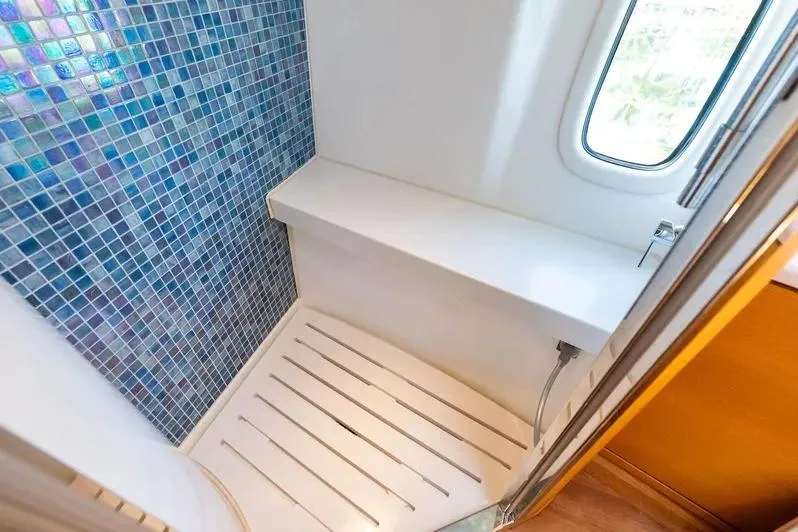 Slide: The Image of Luxurious shower area in 2019 Zeelander Z55 yacht with mosaic tiles and window. - 55