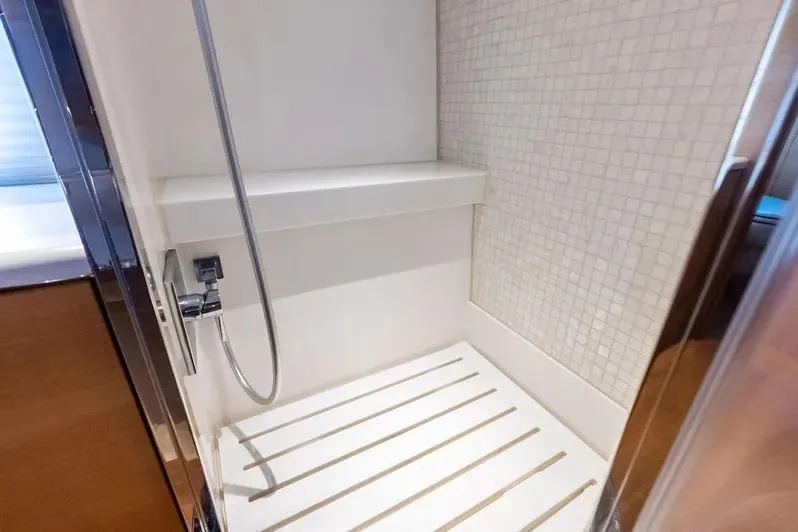 Slide: The Image of Shower area in 2019 Zeelander Z55 yacht with modern fixtures and tiled walls. - 57