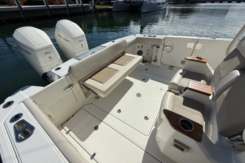 Slide: The Image of 2023 Boston Whaler 360 Outrage boat interior with seating and twin Mercury engines. - 16