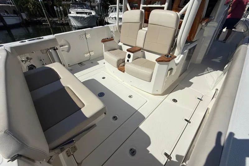 Slide: The Image of 2023 Boston Whaler 360 Outrage interior with beige seating and sleek design. - 19