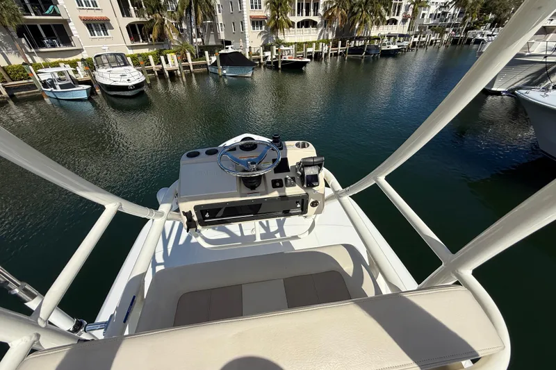 Slide: The Image of Boston Whaler 360 Outrage 2023 helm overlooking marina with docked boats. - 23