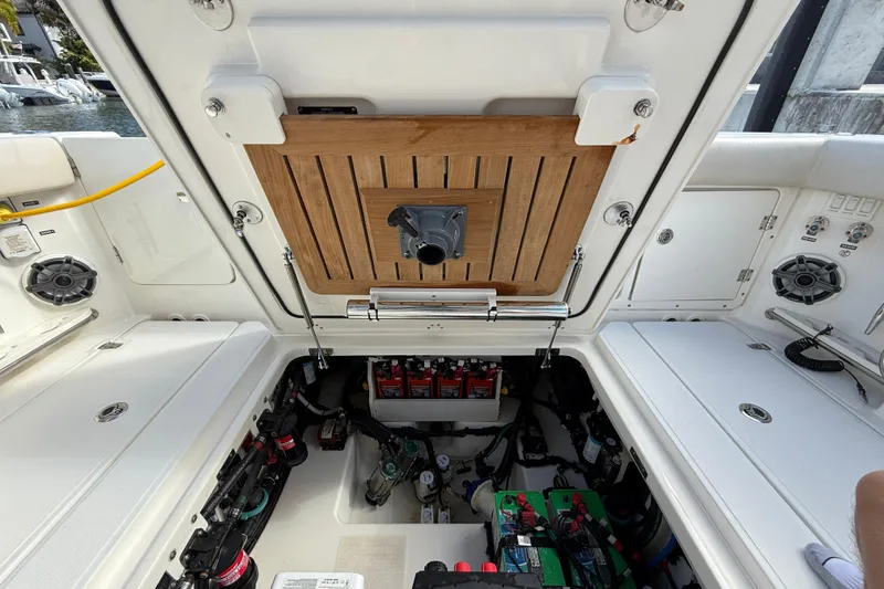 Slide: The Image of 2023 Boston Whaler 360 Outrage engine compartment with batteries and wiring. - 28