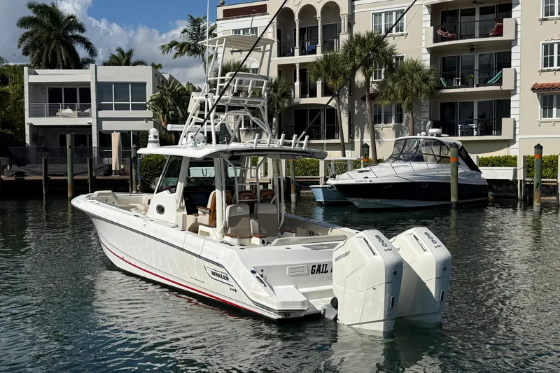 Slide: The Image of 2023 Boston Whaler 360 Outrage boat docked near waterfront residences. - 3