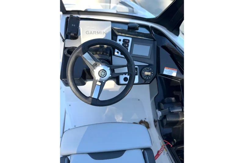 Slide: The Image of 2023 Yamaha Boats SX220 helm with Garmin navigation system and modern controls. - 8