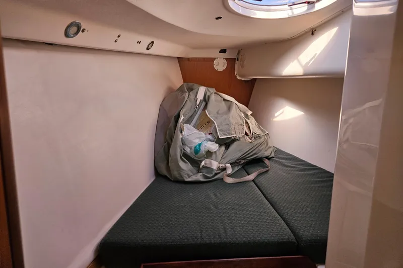 Slide: The Image of Cozy cabin interior of 2001 Farr 395 sailboat with cushions and storage bag. - 16