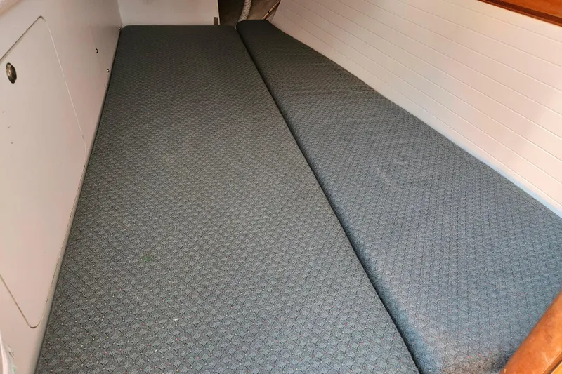 Slide: The Image of Interior cabin view of a 2001 Farr 395 sailboat with cushioned seating. - 17