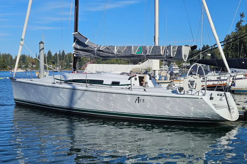 Slide: The Image of Sailboat Farr 395, 2001 model, docked in a marina under clear blue skies. - 2