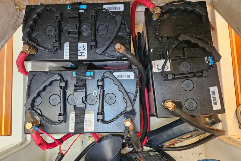 Slide: The Image of Four marine batteries in a Farr 395 yacht, 2001 model, with red and black cables. - 21