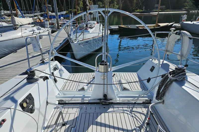 Slide: The Image of Cockpit of a 2001 Farr 395 sailboat docked at a marina, featuring a sleek design. - 7